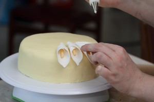 placing the fondant calla lilies on the cake (photo by LdV)
