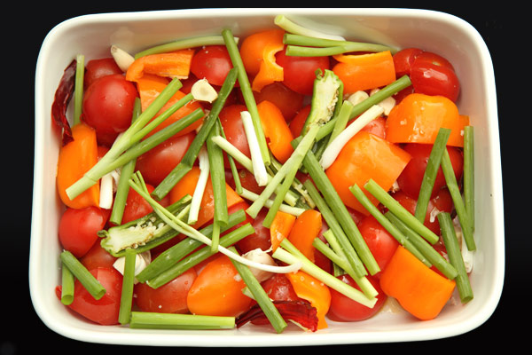 vegetables in casserole dish, ready to be roasted