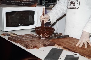 After cooling part of the chocolate down to 27 degrees, the chocolatier places it back with the warmer part and mixes well so the entire batch reaches the optimum temperature for creating chocolates with a nice gloss and bite.