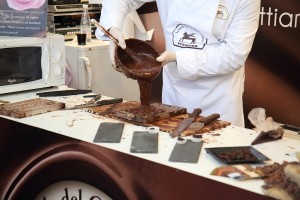 The Perugina chocolatier fills his chocolate mold with the tempered chocolate.