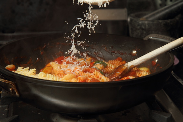 Adding cheese to the pasta dish